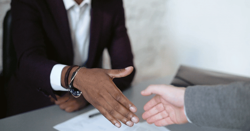 two business people shaking hands over a deal